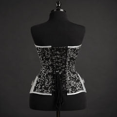 Back studio view of gothic black and silver corset with adjustable criss-cross lacing and shaped lower edge