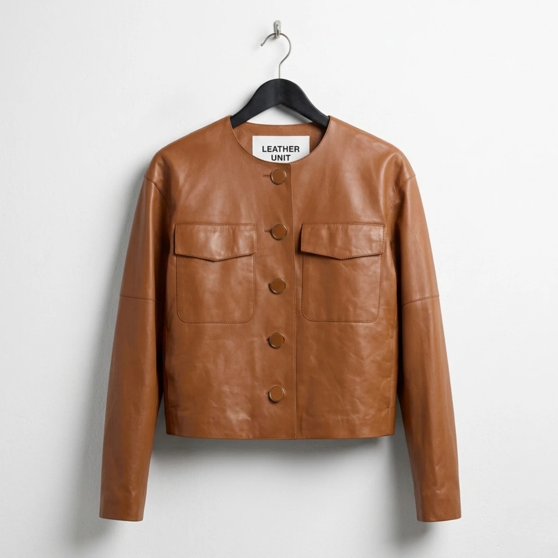 Front view of women’s brown collarless button-down leather jacket by Leather Unit