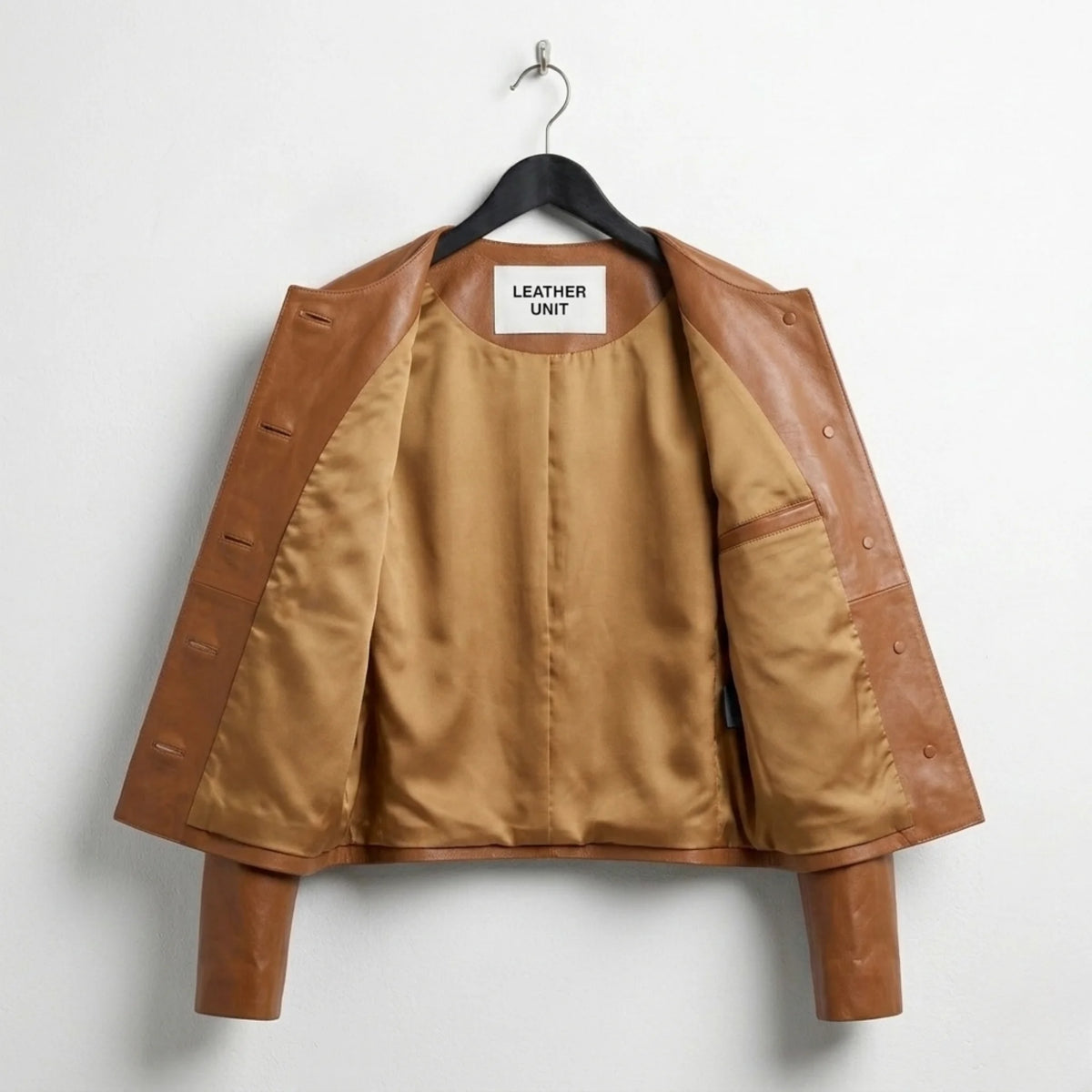 Inside lining of women’s brown collarless leather jacket with inner pocket