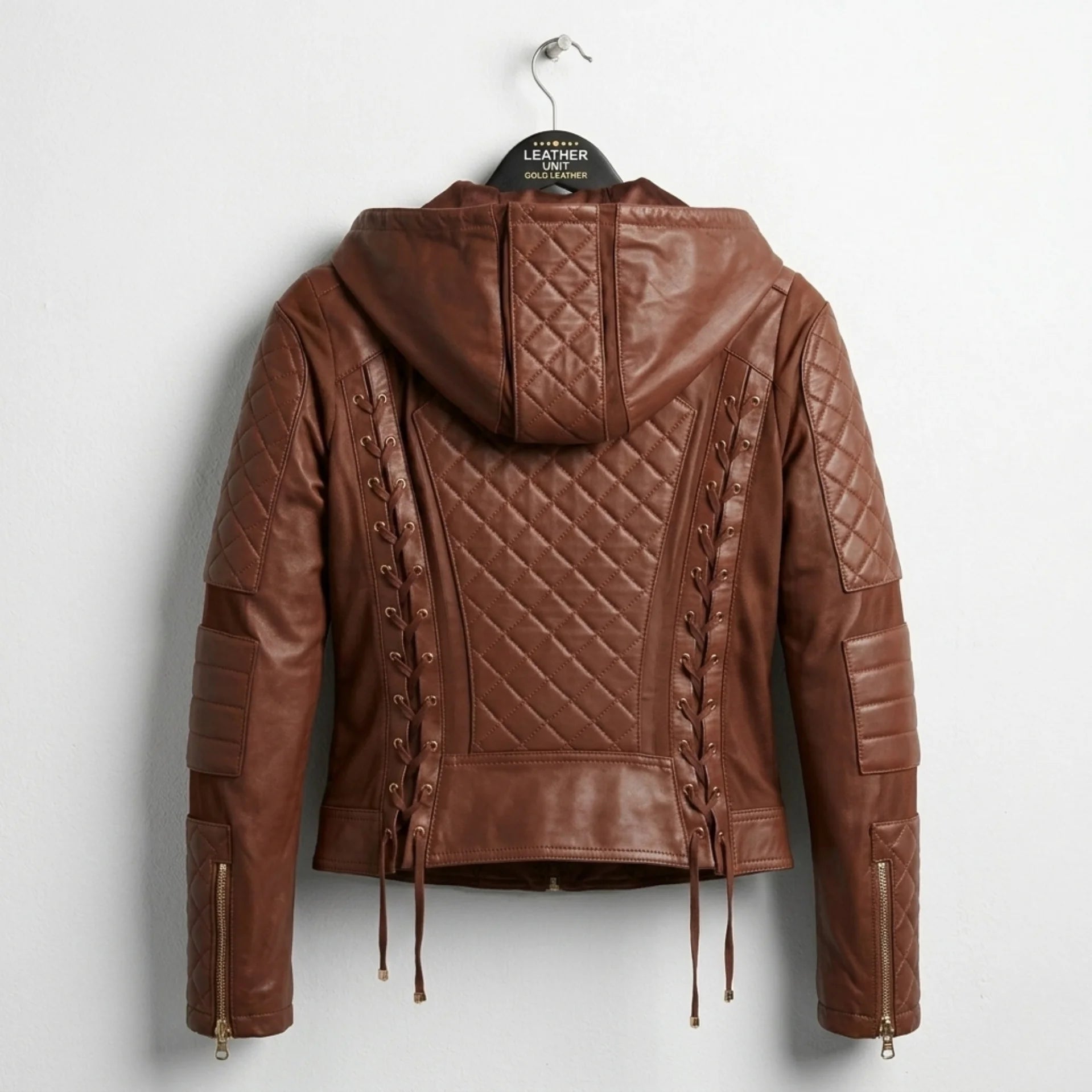 Back view of women’s brown hooded moto leather jacket with quilted panel and lace-up sides.