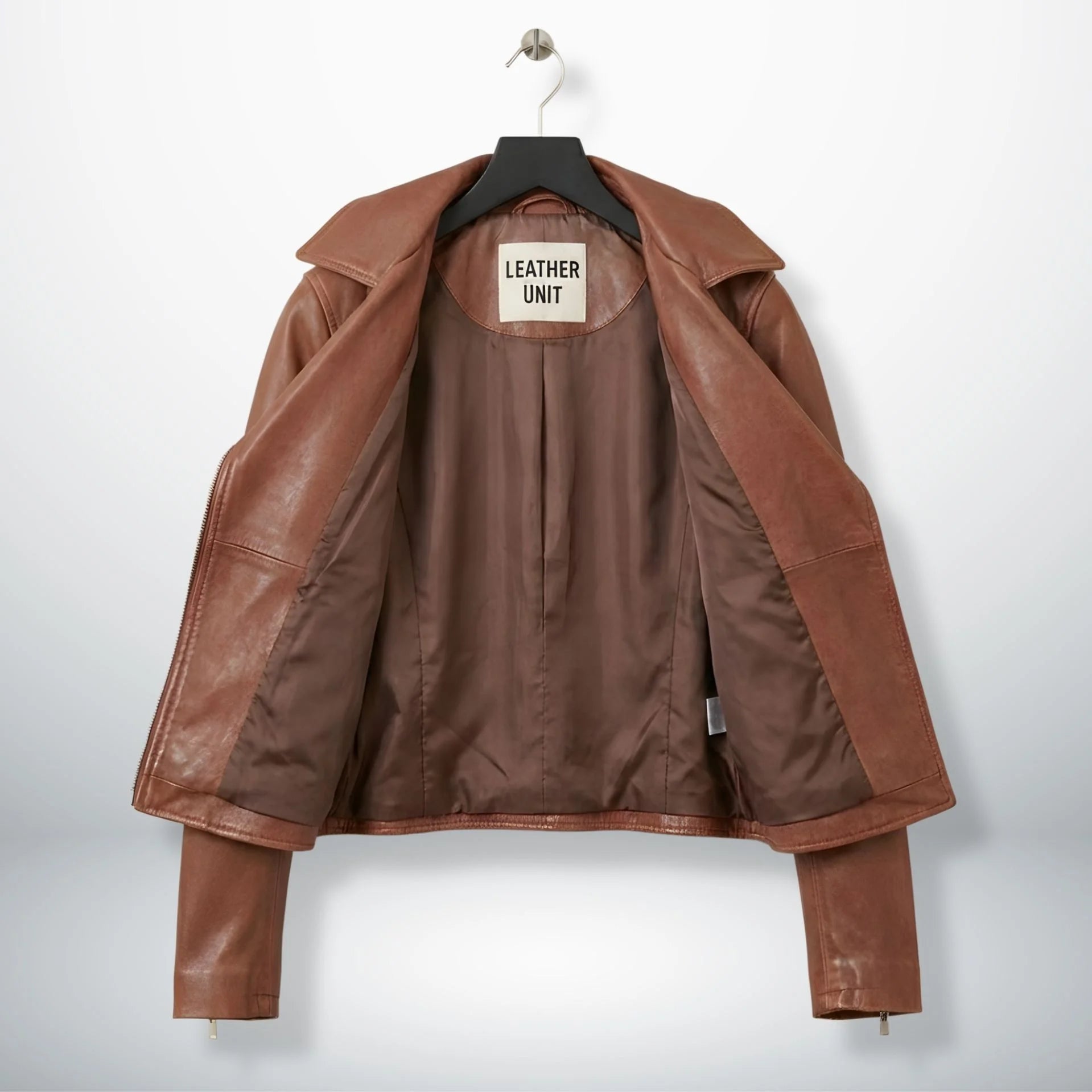 interior of women's brown leather moto jacket showing satin lining.