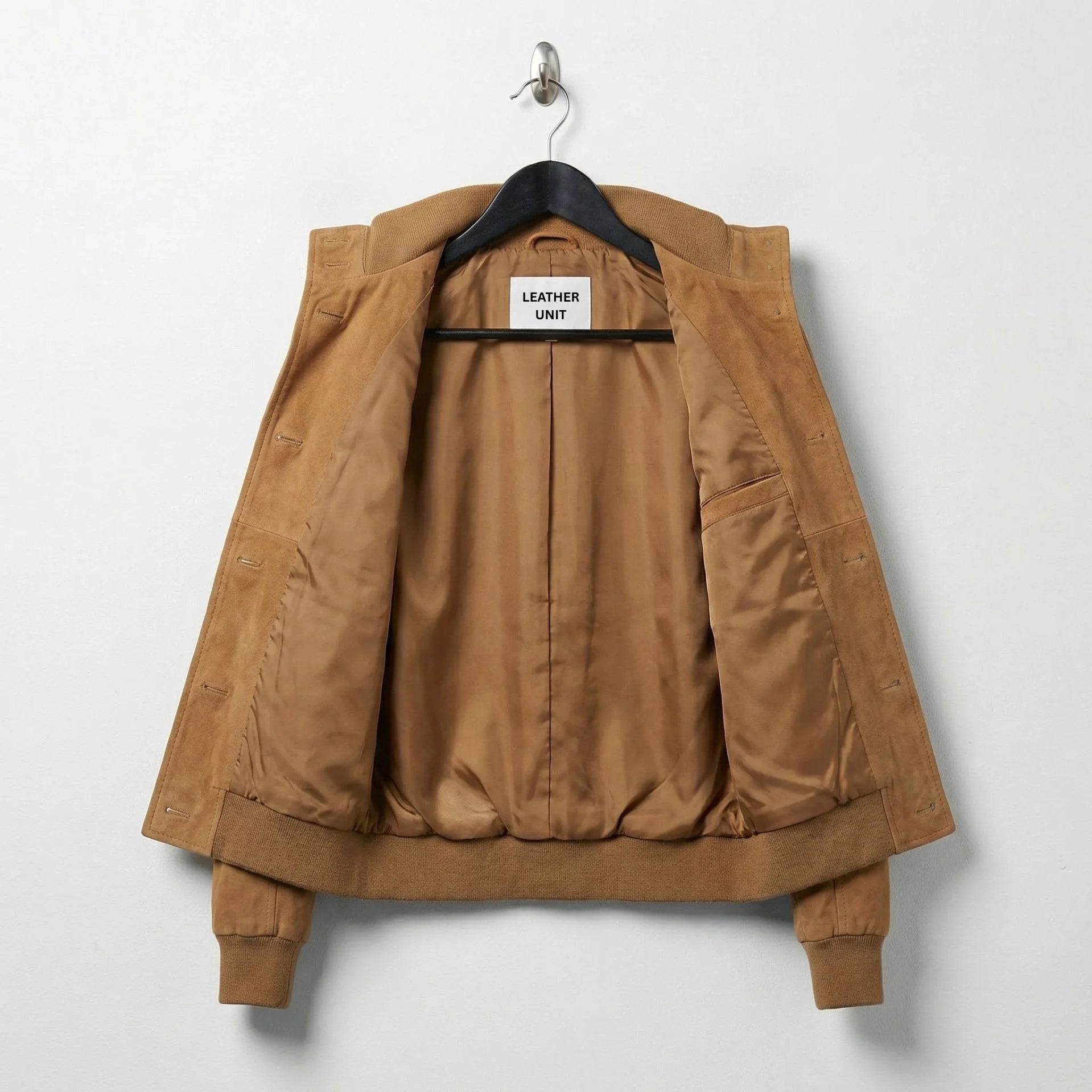Interior lining of women’s brown suede bomber jacket showing inside pocket