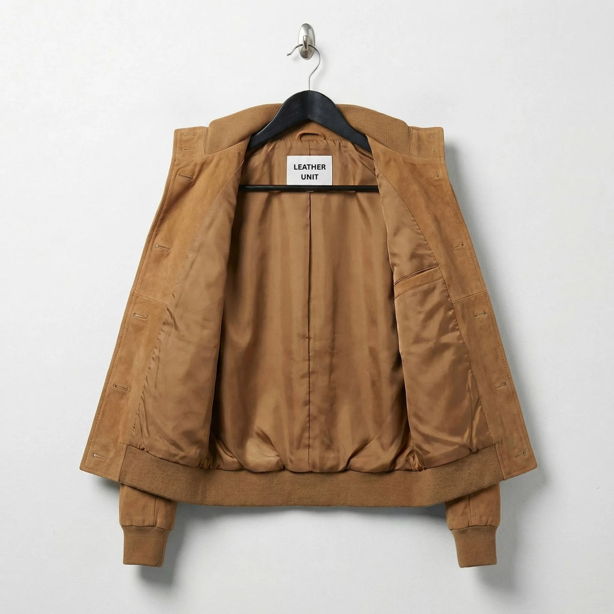 Interior lining of women’s brown suede bomber jacket showing inside pocket