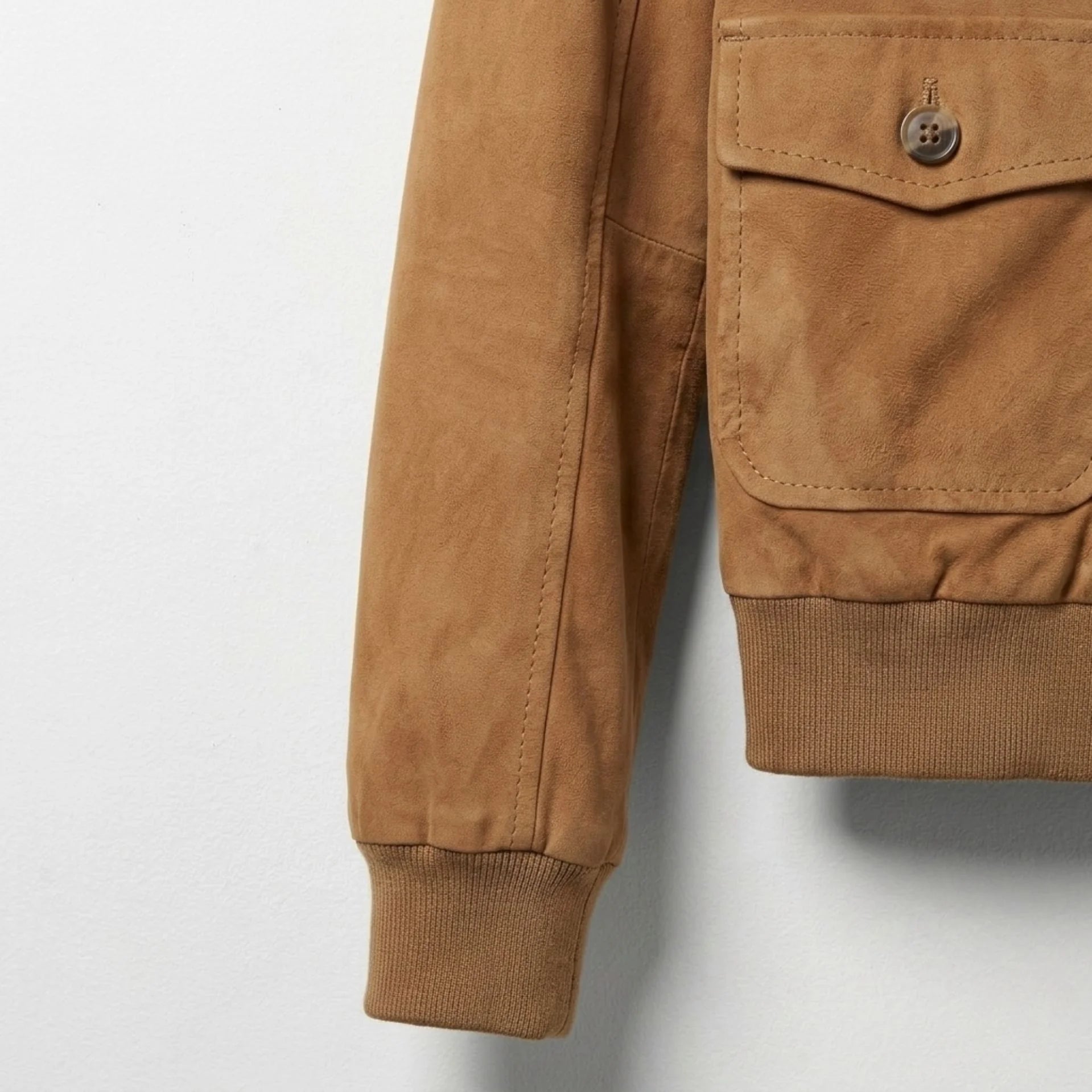 Detail of ribbed cuff on women’s brown suede bomber jacket