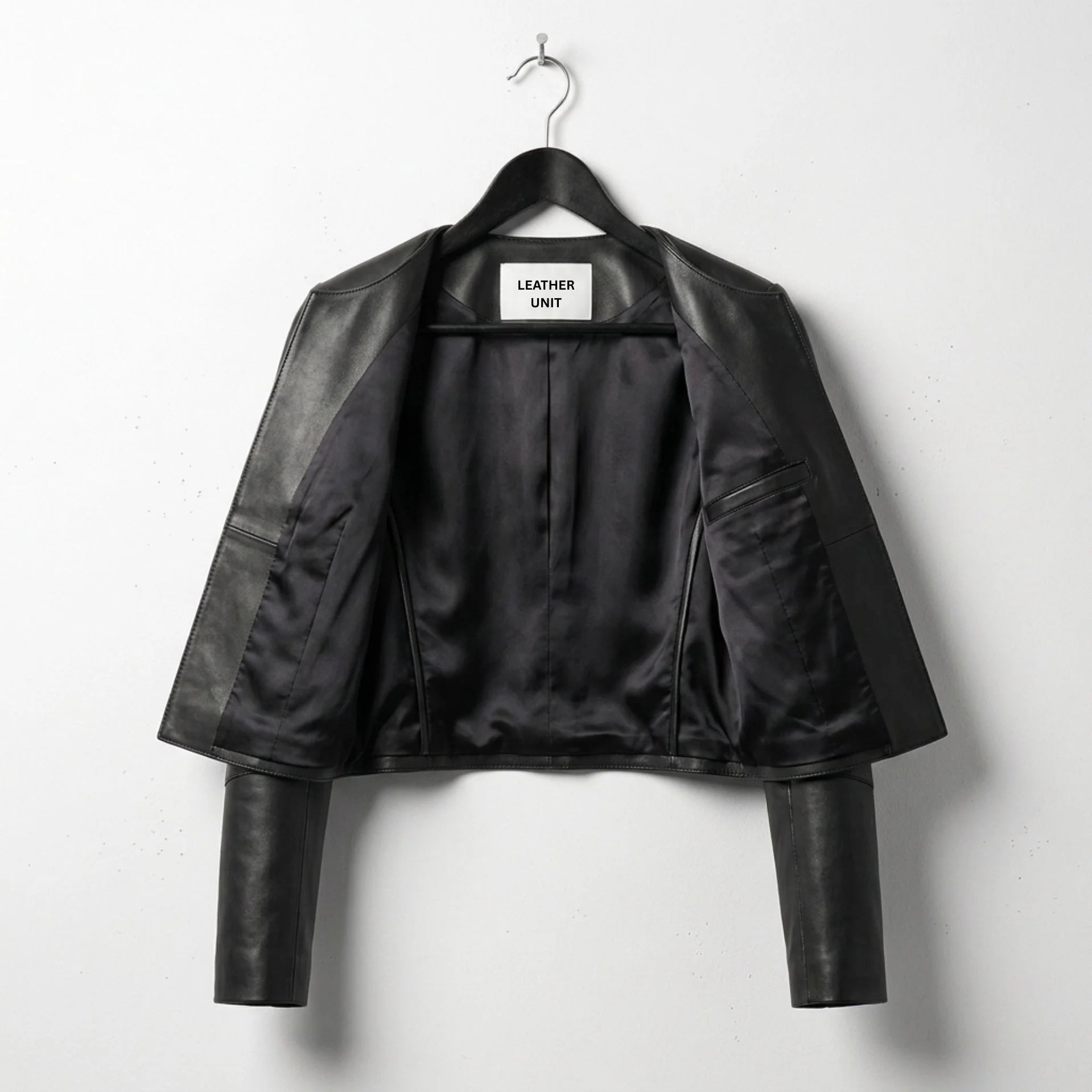 Inside view of women's black cropped leather jacket with full black lining