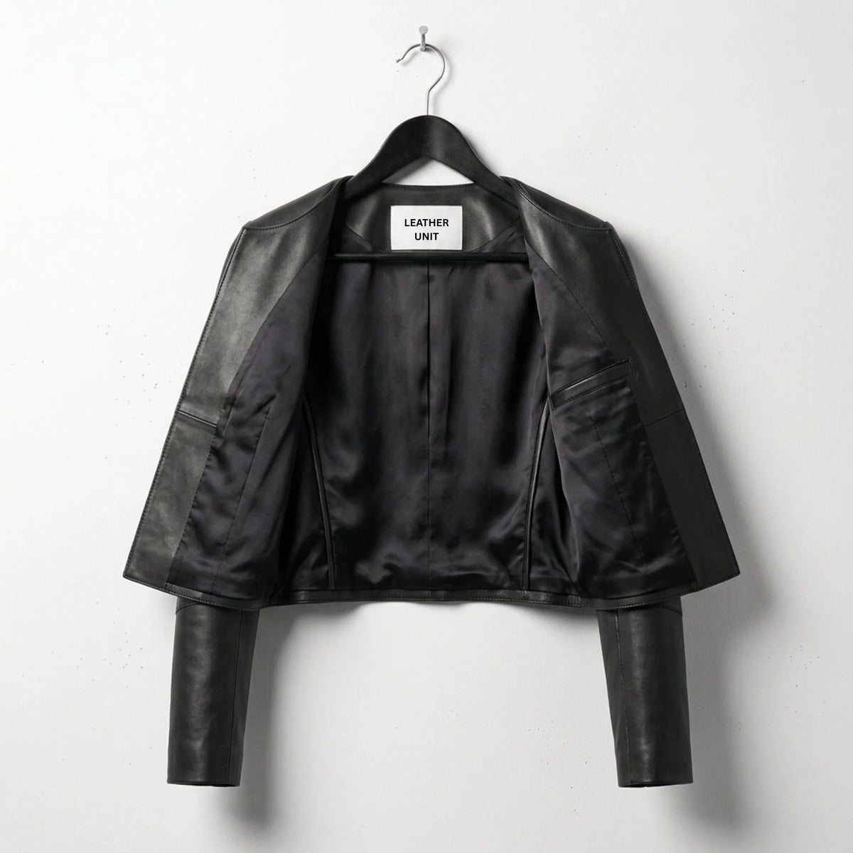 Inside view of women's black cropped leather jacket with full black lining