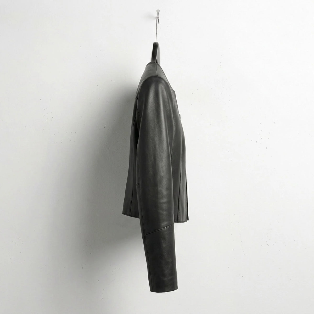 Side profile of minimalist women's cropped leather jacket