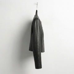 Side profile of minimalist women's cropped leather jacket