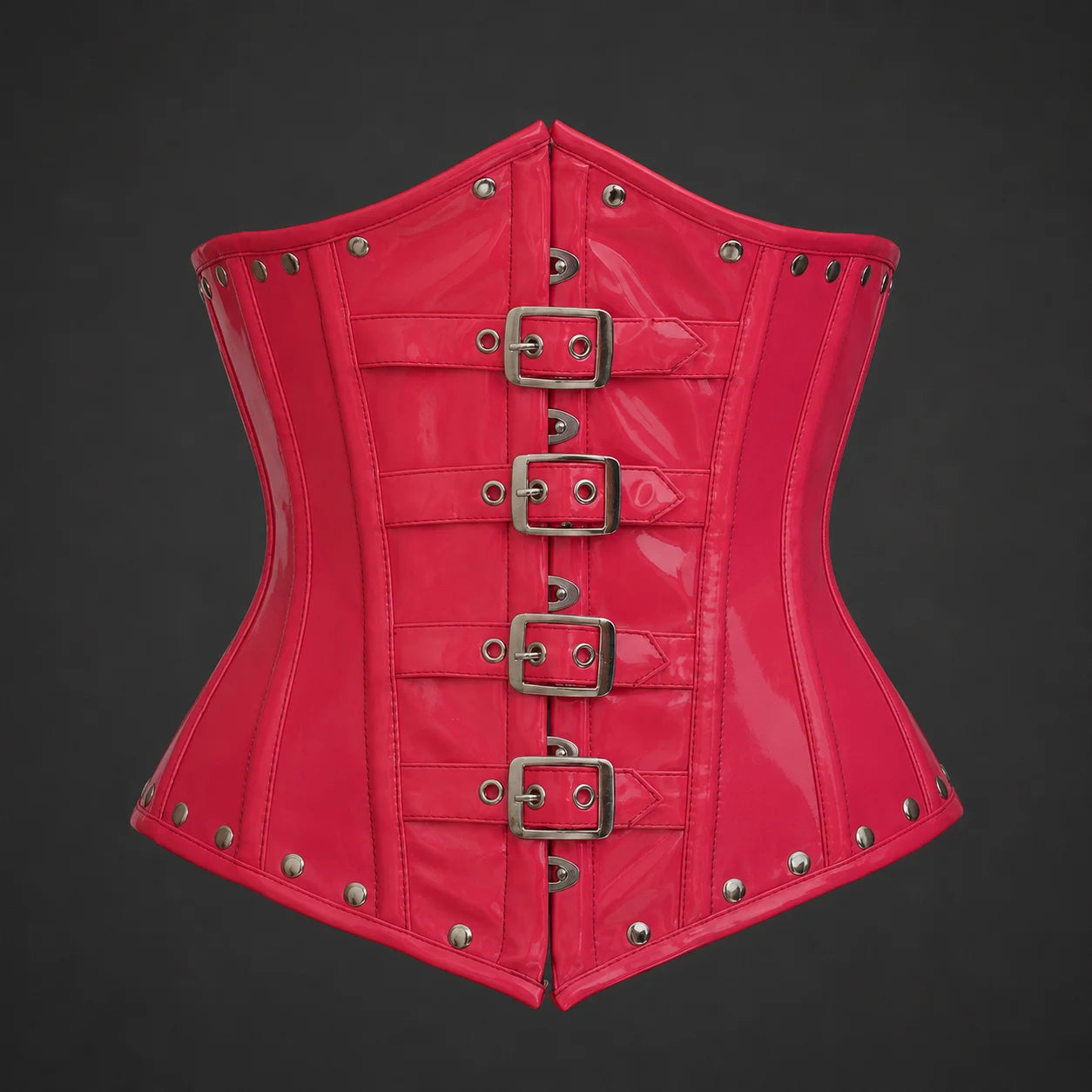 Front studio view of glossy pink PVC underbust corset with four silver-tone buckle straps and rivet trim