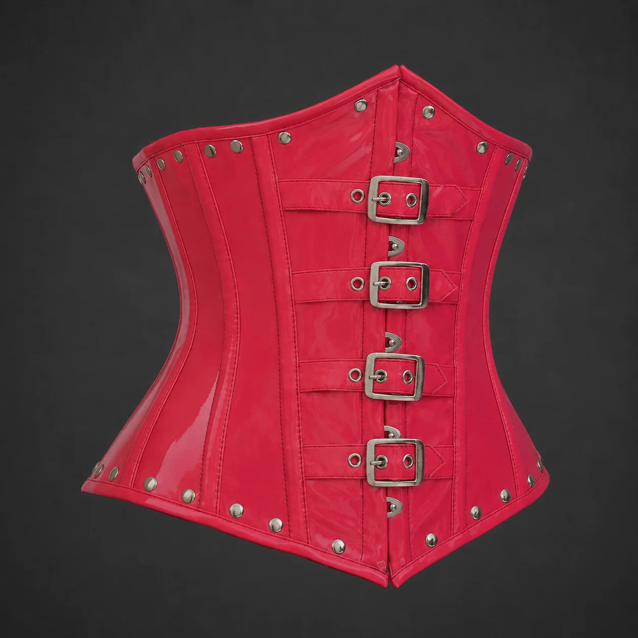 Three-quarter product view of pink PVC corset highlighting curved waist shaping, buckles and metal-look rivets
