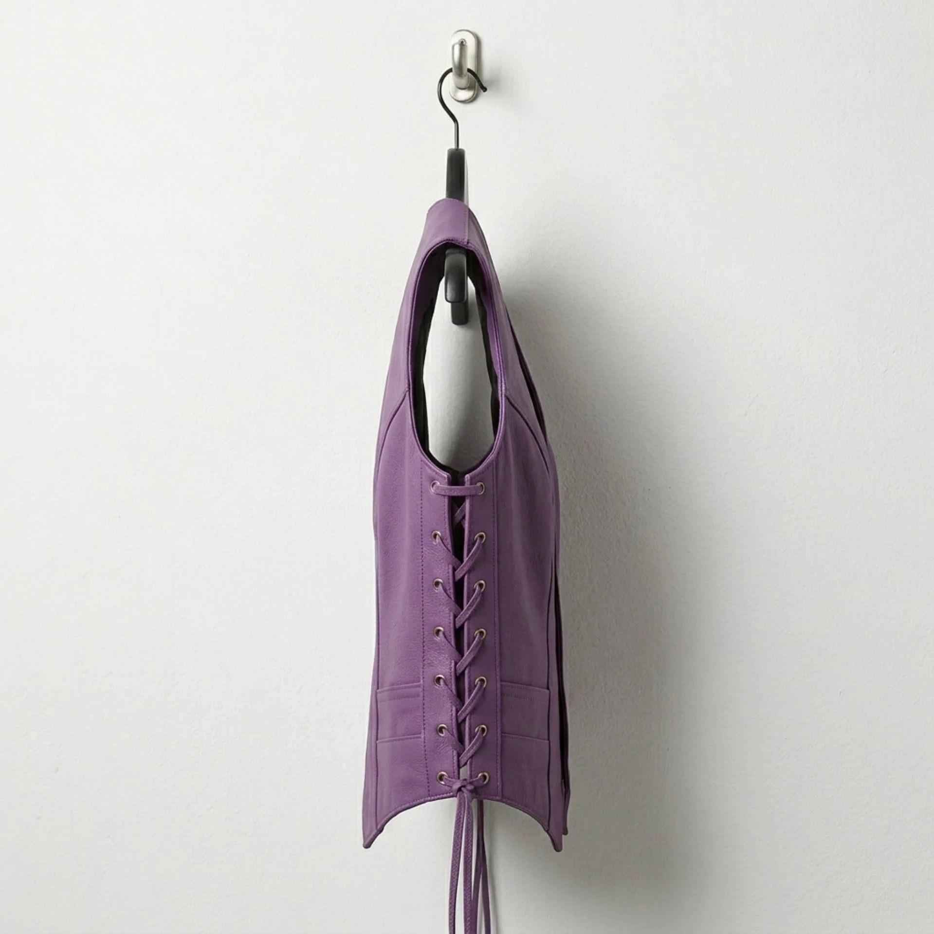 Side profile of women’s purple leather vest with lace up sides