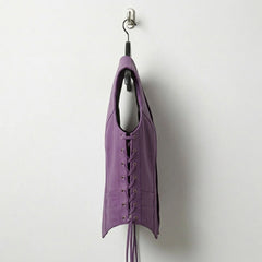 Side profile of women’s purple leather vest with lace up sides