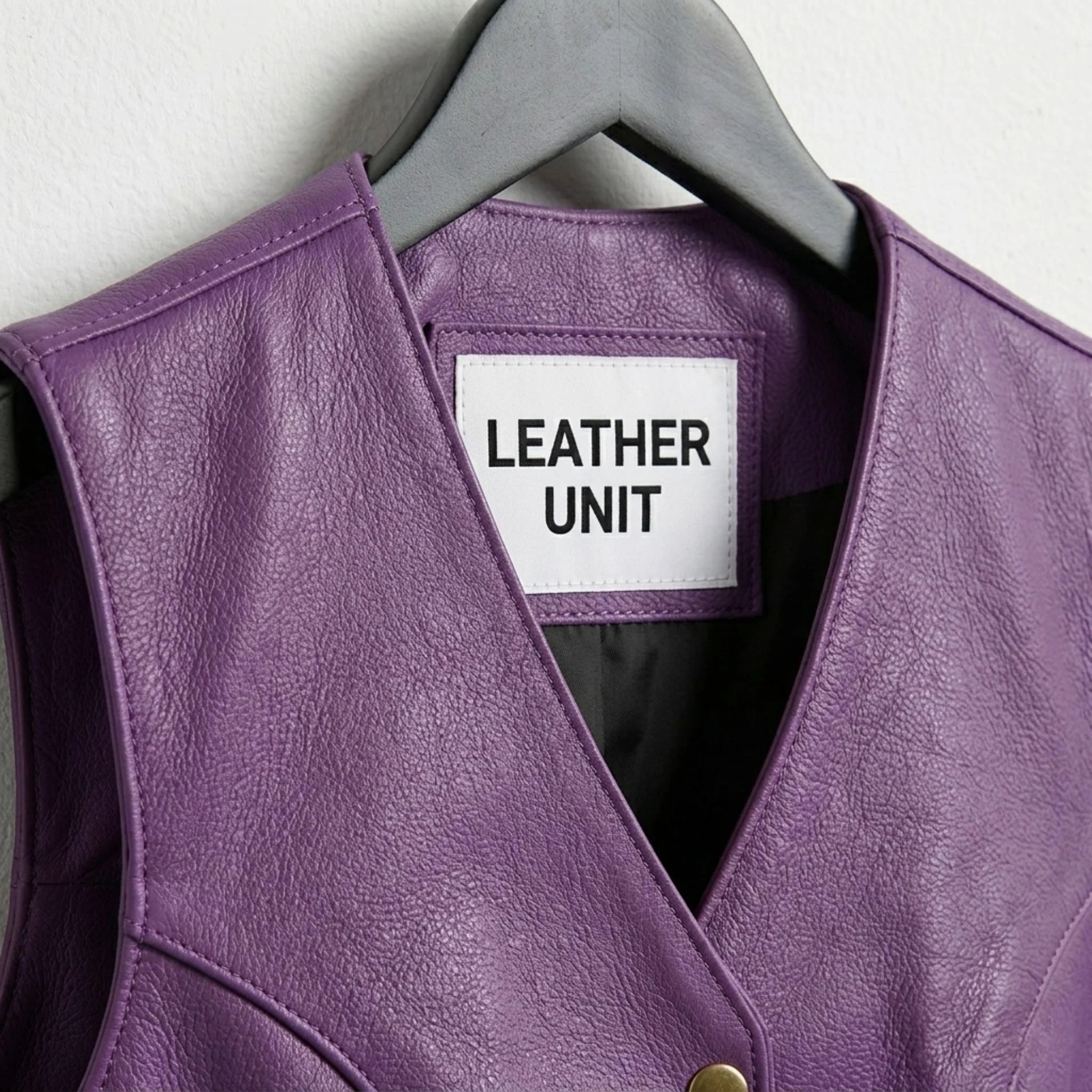 Close up of neckline and label on Leather Unit purple leather vest