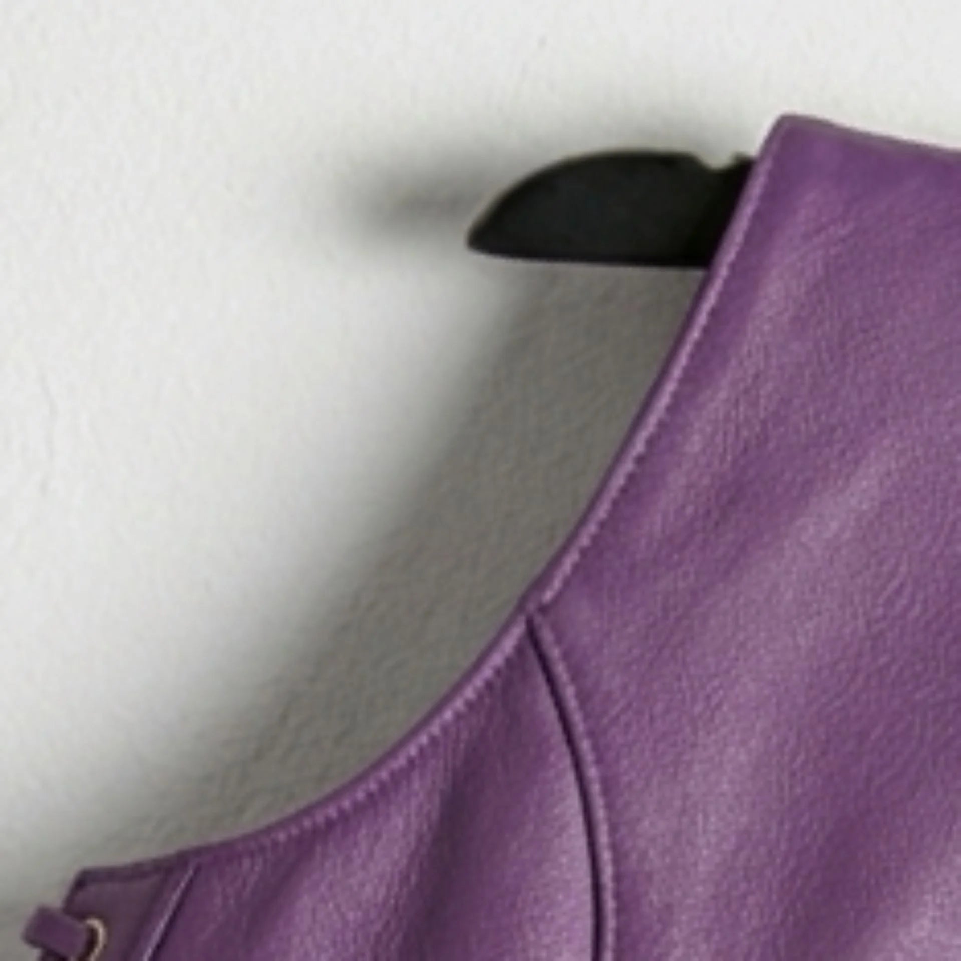 Close up of leather texture on shoulder of women’s purple vest