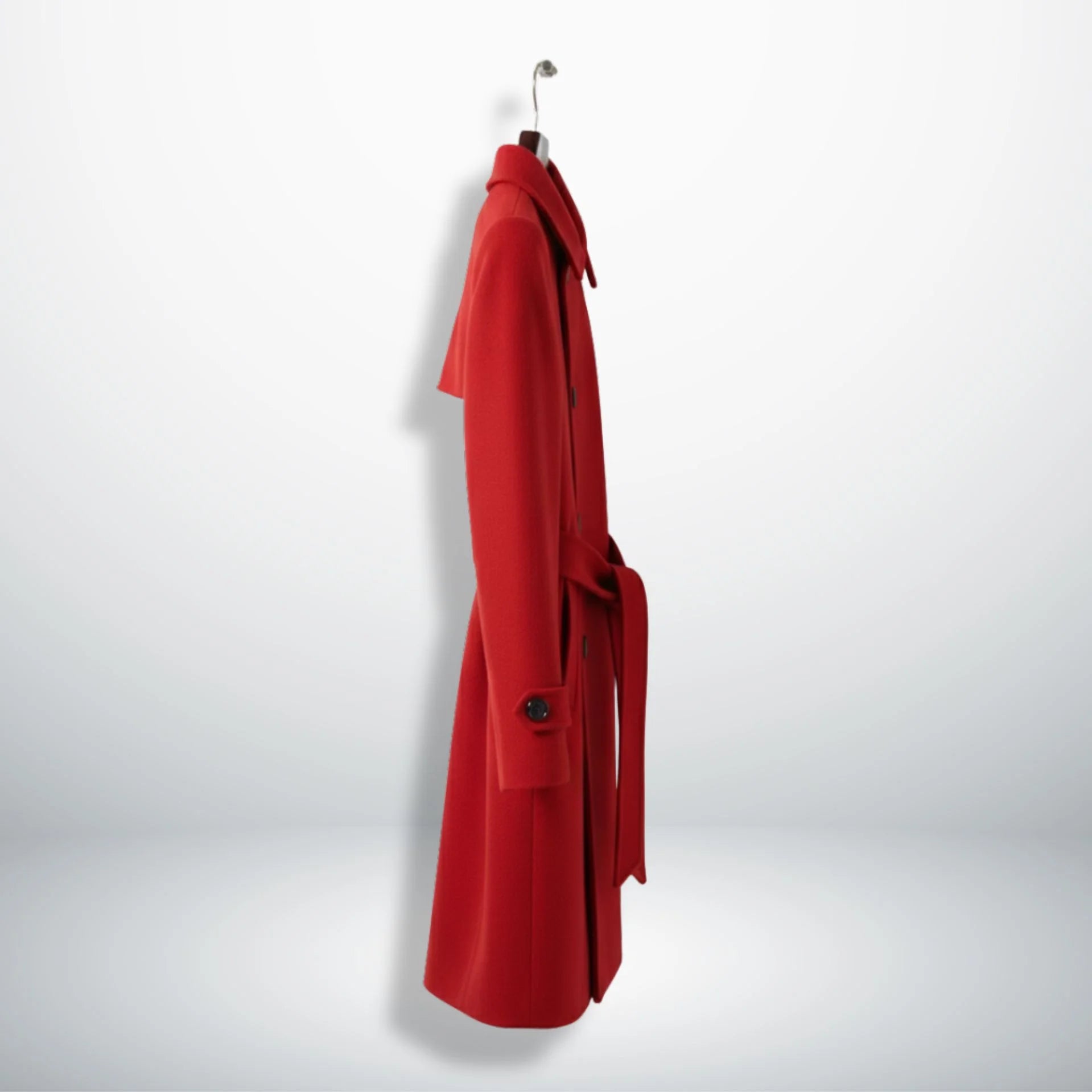 Side profile of belted women’s red single breasted wool coat