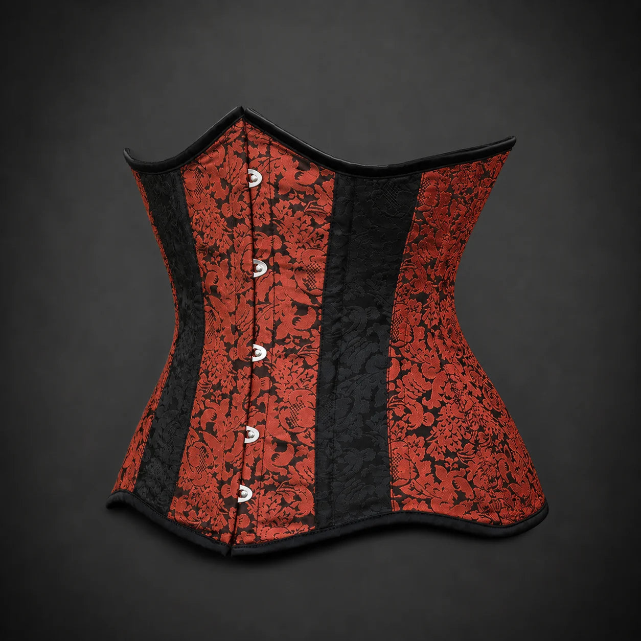 Three-quarter product angle showing curved waist shape, ornamental red brocade, black panels and front fastening detail