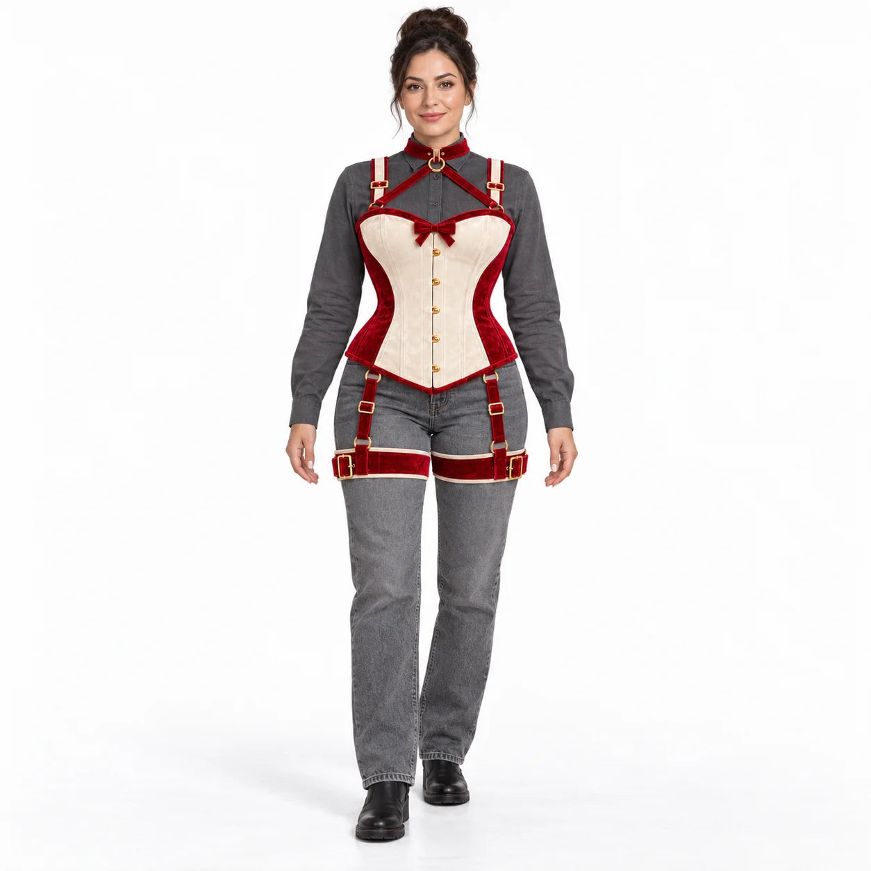 Full-length studio styling of women's red and ivory corset harness set worn with a grey blouse and jeans