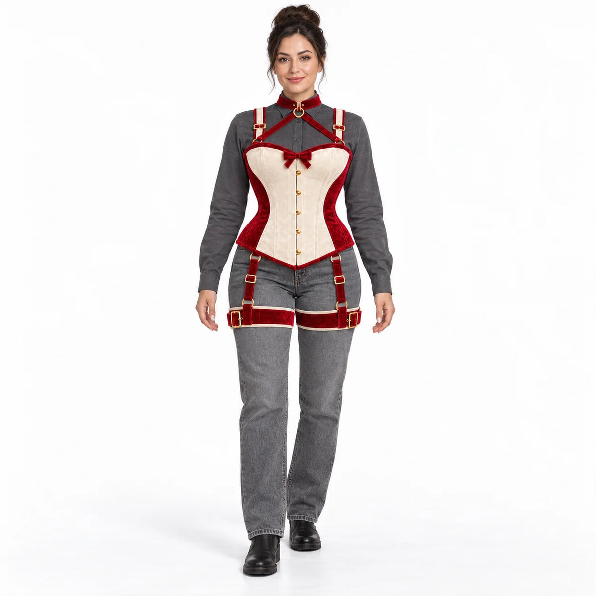 Full-length studio styling of women's red and ivory corset harness set worn with a grey blouse and jeans