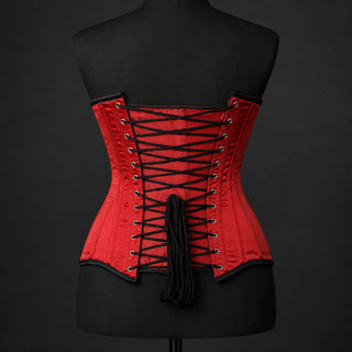 Back studio view of red satin corset with black adjustable lacing, metal-look eyelets and structured waist