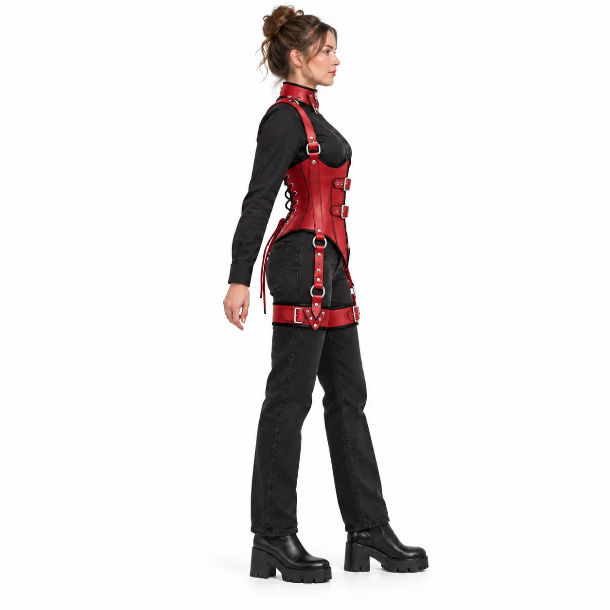 Side view of woman wearing a fitted scarlet red leather underbust corset with black piping and adjustable thigh harness.
