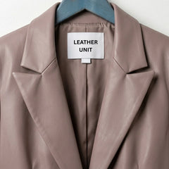 Close up of notch lapels and label on Leather Unit taupe leather blazer