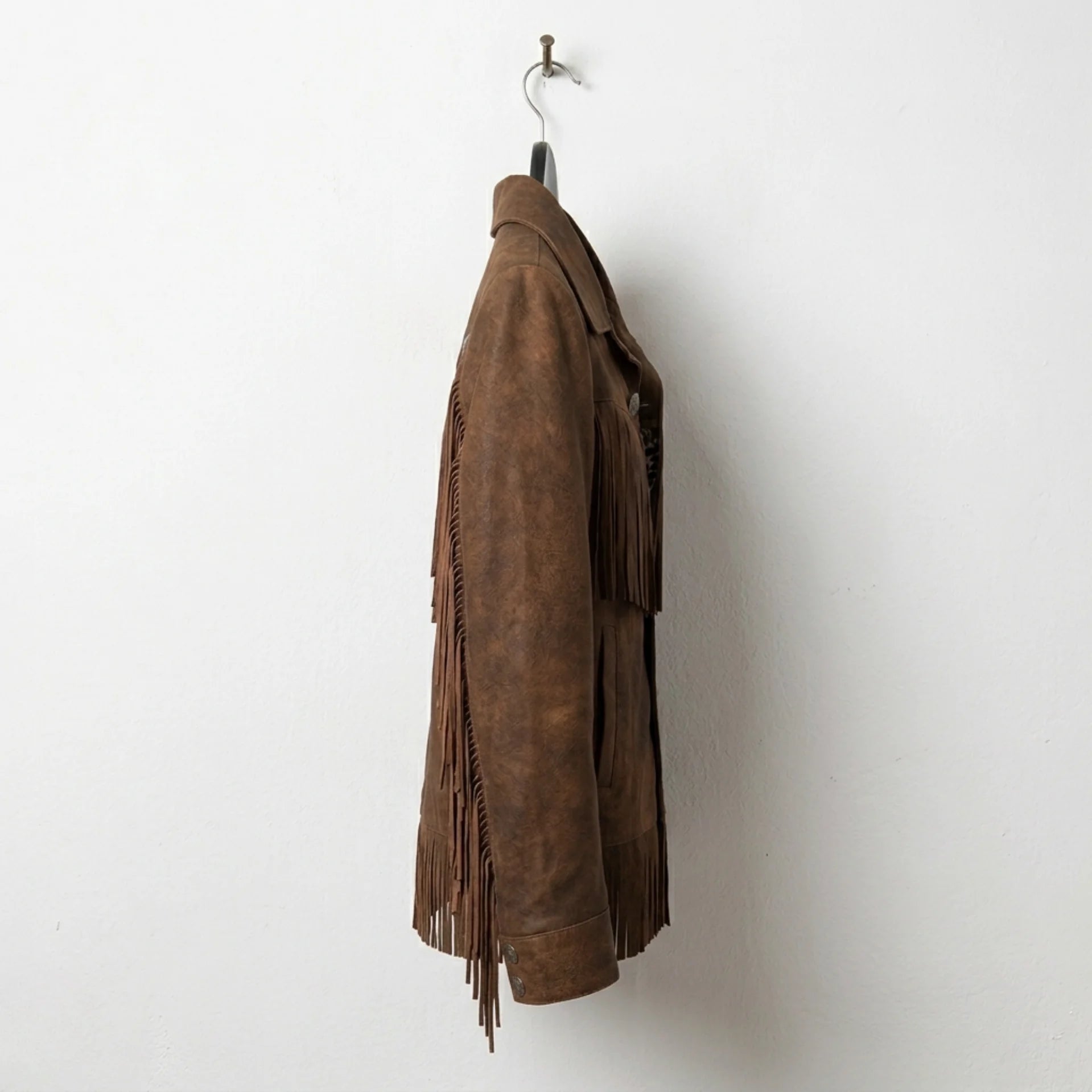 Side profile of women’s vintage brown fringe leather jacket
